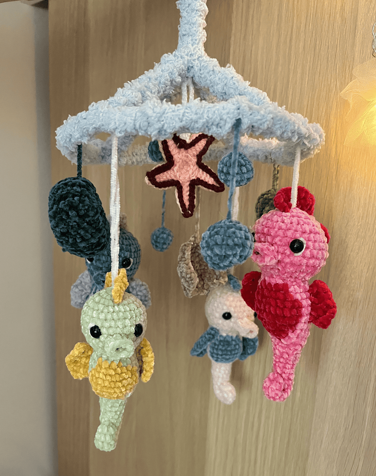 Handmade crochet Seahorse Ocean Mobile with four seahorses, seashells and fluffy light blue frame