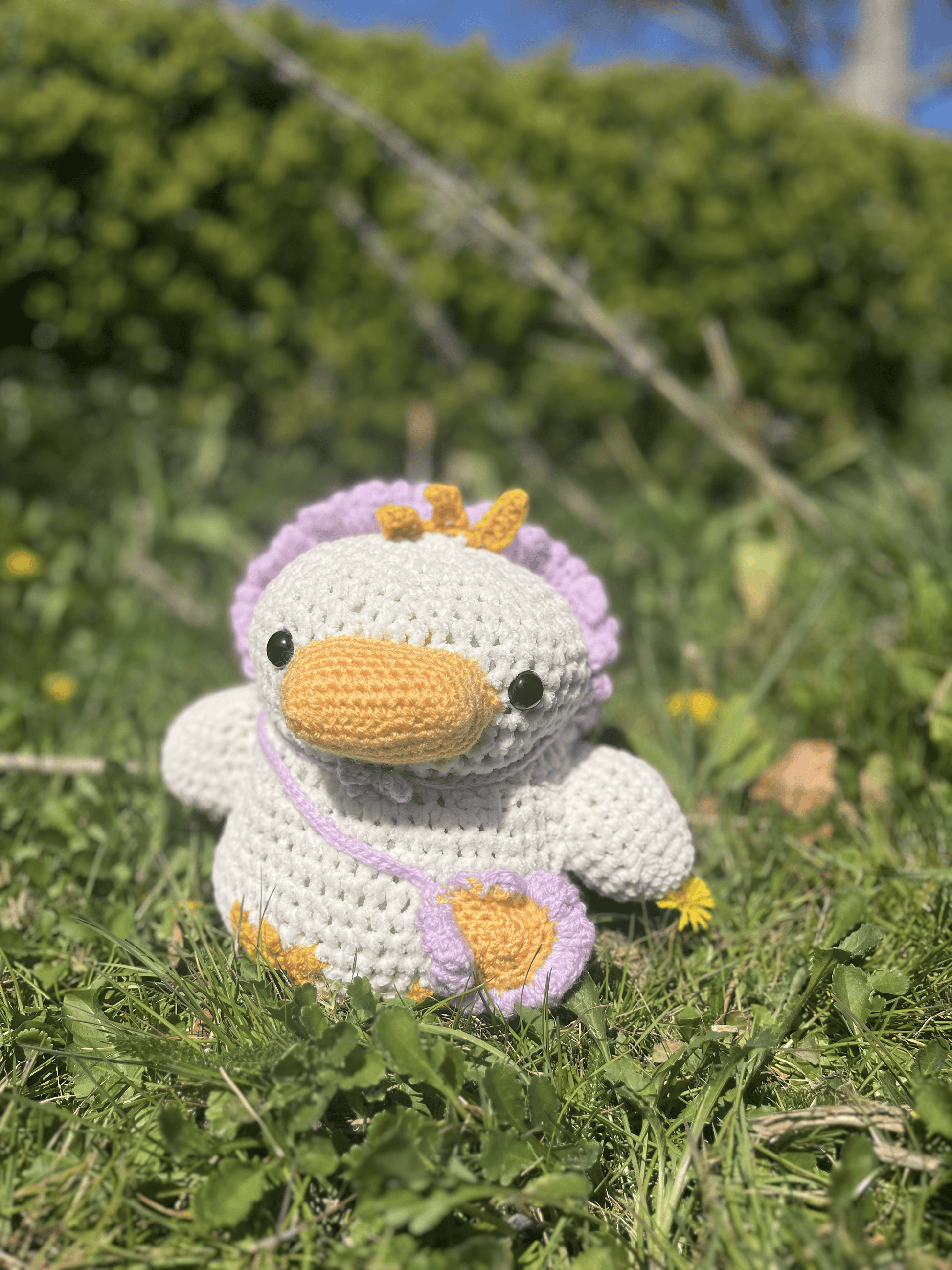 Crochet duckling plush with removable flower hat and tiny satchel, floral Easter toy and handmade amigurumi animal
