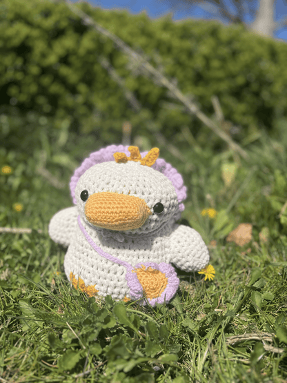 Crochet duckling plush with removable flower hat and tiny satchel, floral Easter toy and handmade amigurumi animal