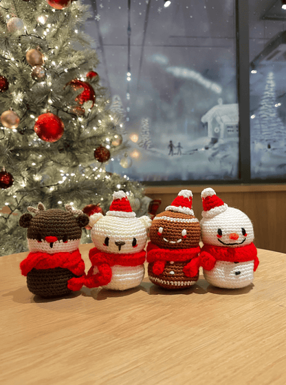 Handmade crochet Christmas decoration set featuring Rudolph, polar bear, gingerbread man and snowman for festive mantel and shelf decor