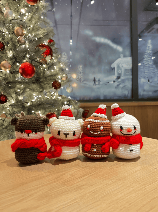 Handmade crochet Christmas decoration set featuring Rudolph, polar bear, gingerbread man and snowman for festive mantel and shelf decor