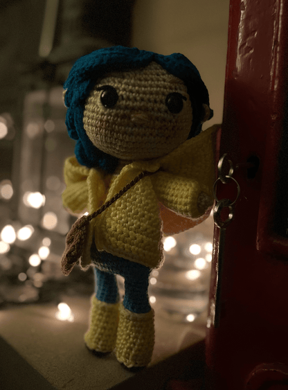 Handmade Coraline crochet doll with blue hair, yellow raincoat and normal eyes without buttons