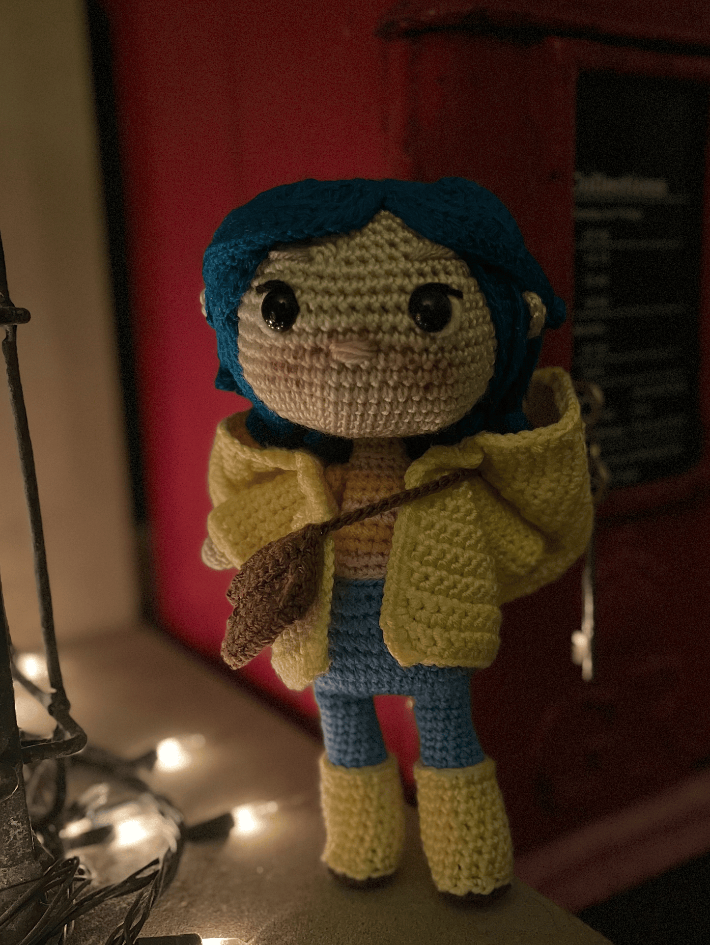 Handmade Coraline crochet collectible styled with gothic and dark fantasy shelf decor
