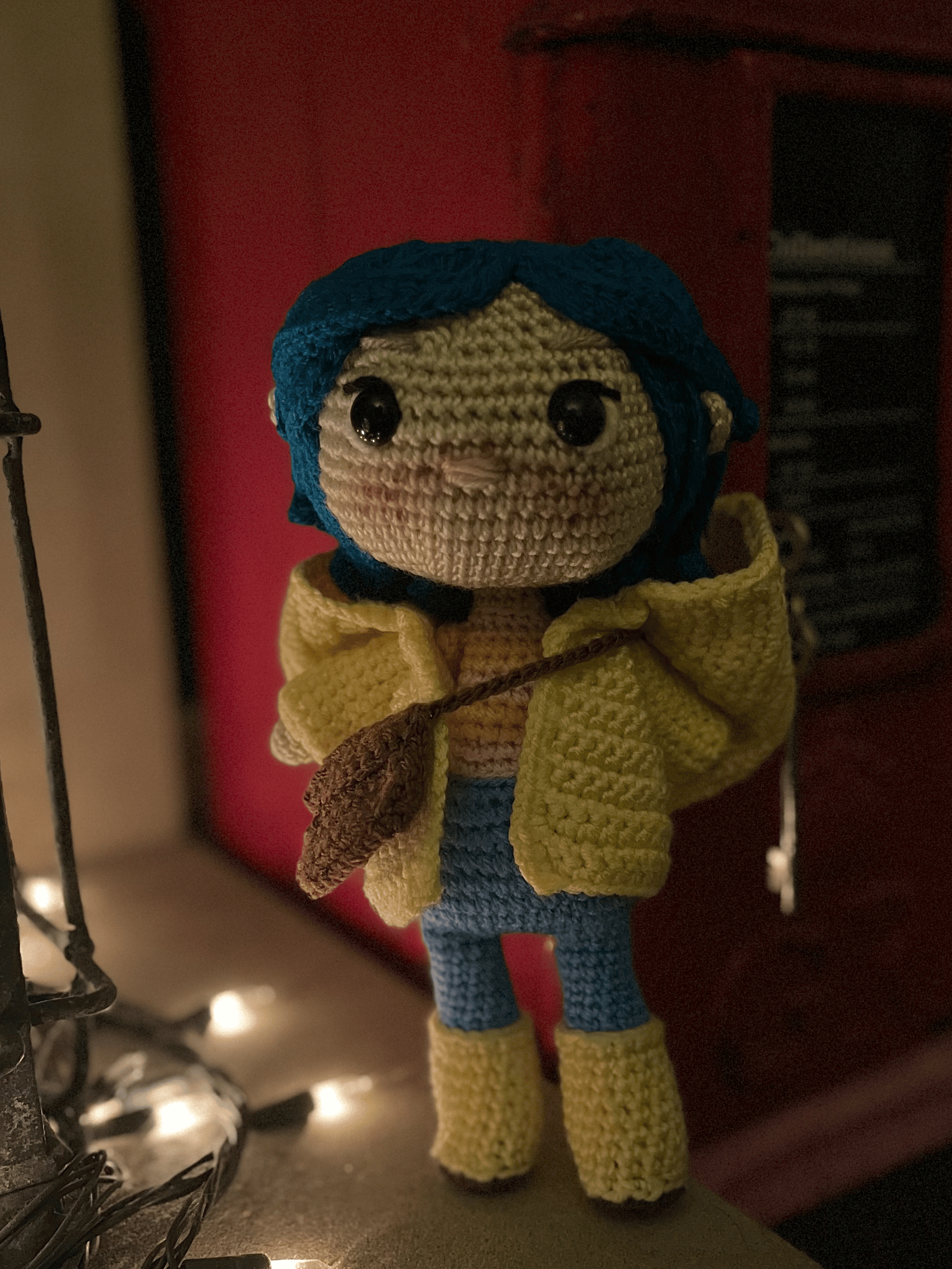 Handmade Coraline crochet collectible styled with gothic and dark fantasy shelf decor