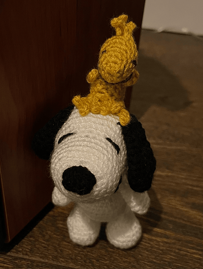 Crochet Snoopy and Woodstock keychain featuring the iconic Peanuts duo, handmade character accessory and collectible