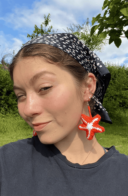 Handmade crochet starfish earrings styled with summer clothing, ocean-inspired jewellery and coastal fashion accessory
