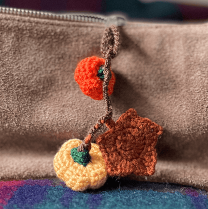 Crochet pumpkin and maple leaf keychain, handmade autumn accessory and seasonal fall bag charm