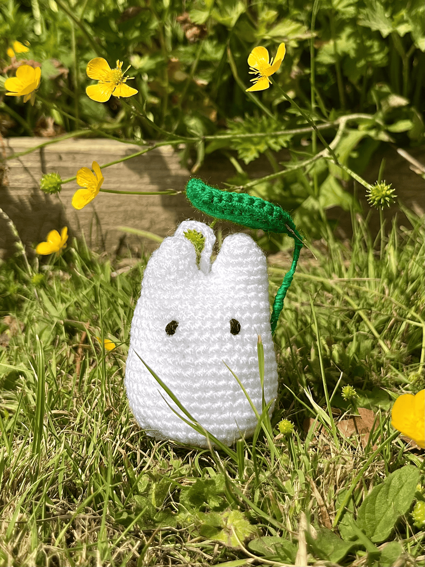 Close-up of handmade White Totoro crochet keychain inspired by My Neighbour Totoro and Studio Ghibli